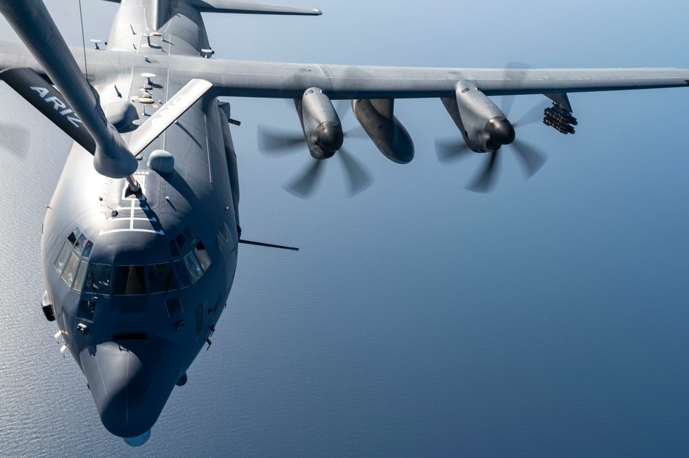 AC-130J Ghostrider in flight during aerial refueling with 30mm cannon visible