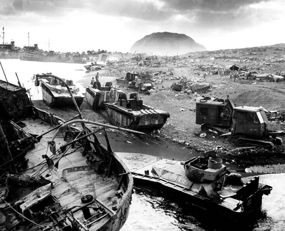 U.S. Marine amtracs approaching the beaches of Iwo Jima with Mount Suribachi visible in the background