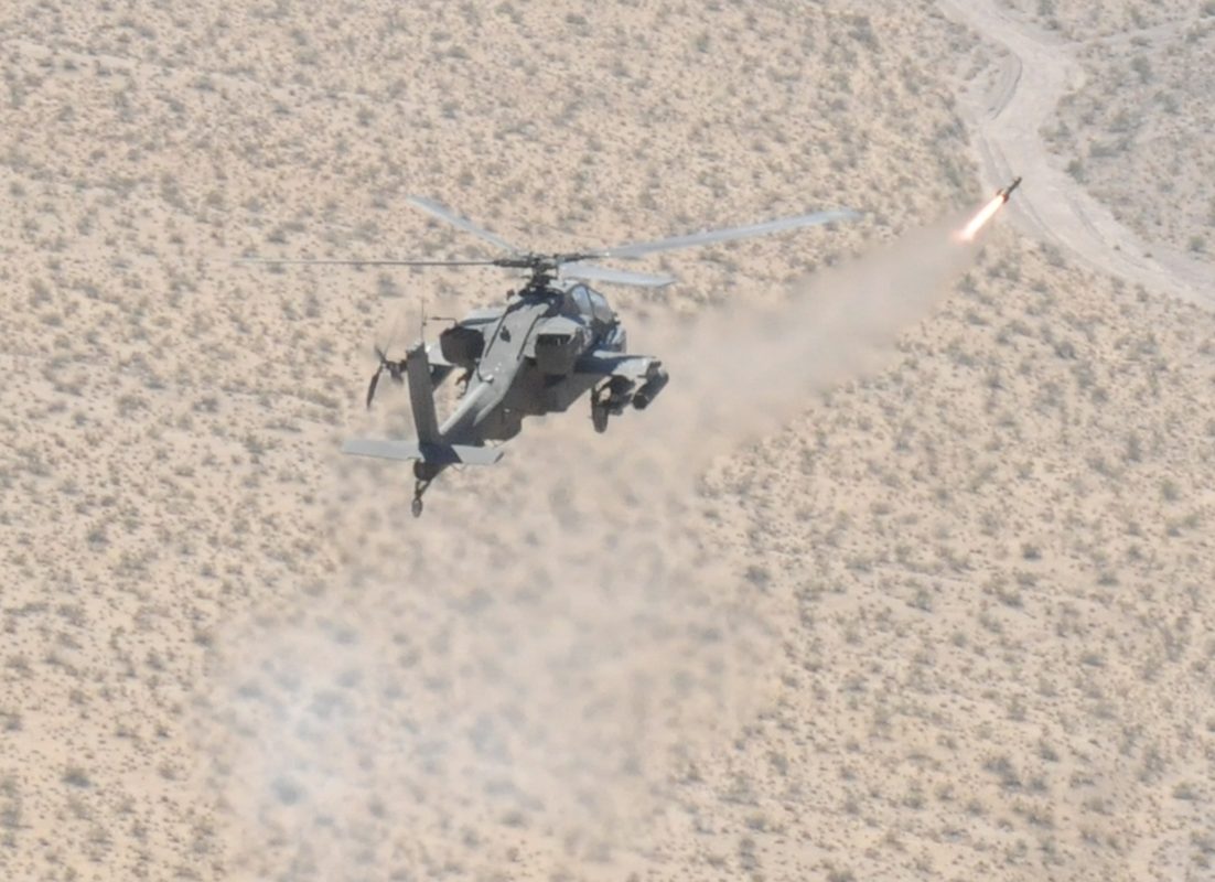 Apache attack helicopter firing an AGM-114 Hellfire missile during a live fire exercise at Fort Irwin