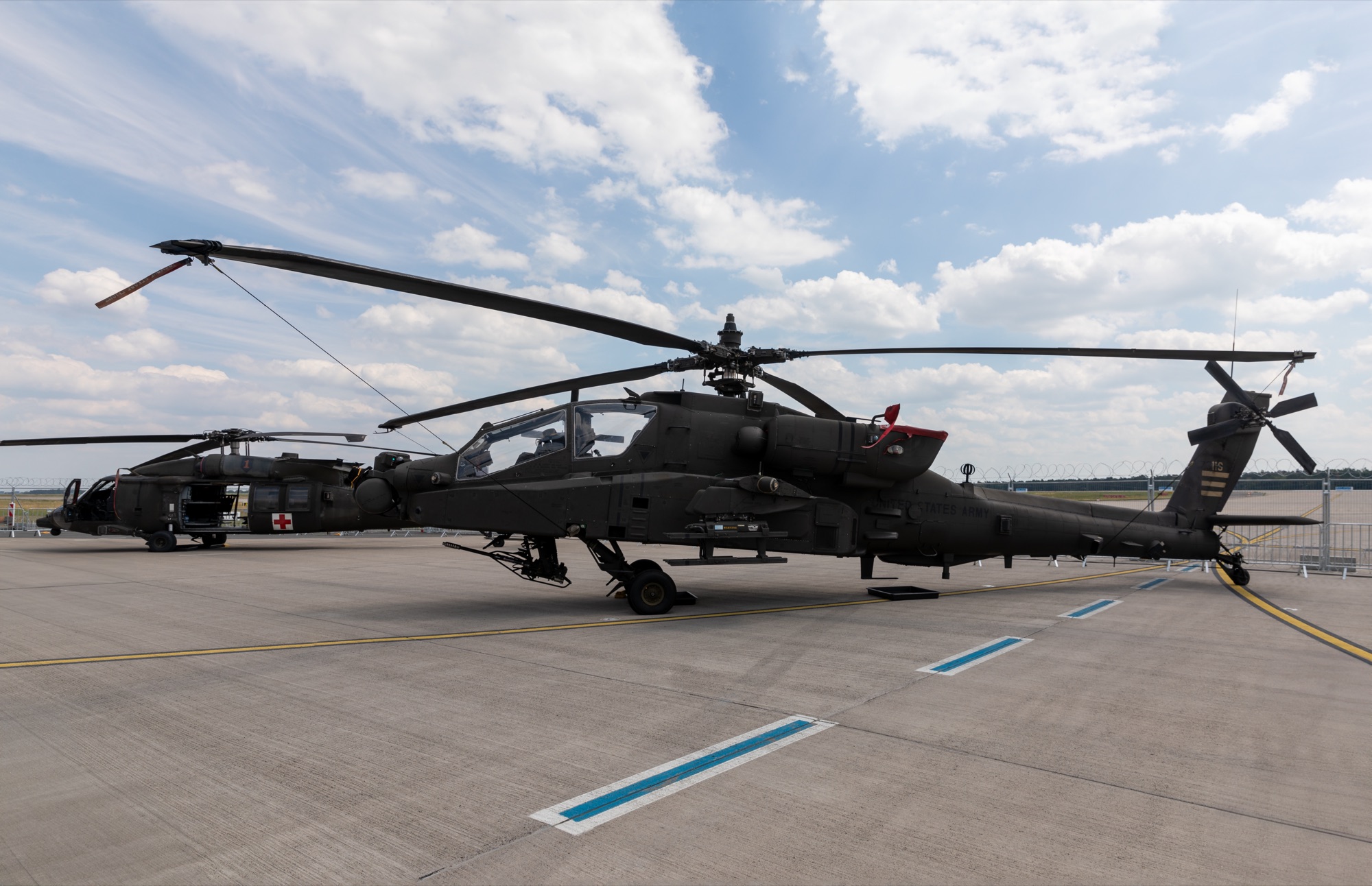 Side-by-side comparison showing the AH-64 Apache's tandem cockpit design versus the Ka-52 Alligator's side-by-side seating and coaxial rotors