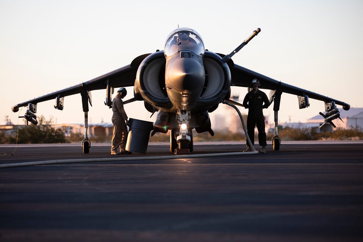 AV-8B Harrier II taking off from a forward expeditionary airstrip in a desert environment
