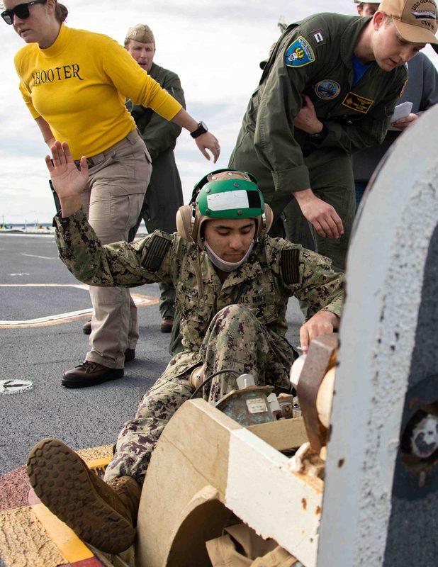 Flight deck crew operating the EMALS electromagnetic catapult system aboard USS Gerald R. Ford