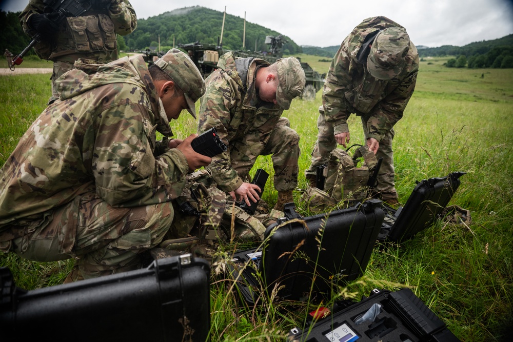 Soldier using a handheld counter-drone RF jammer aimed at the sky