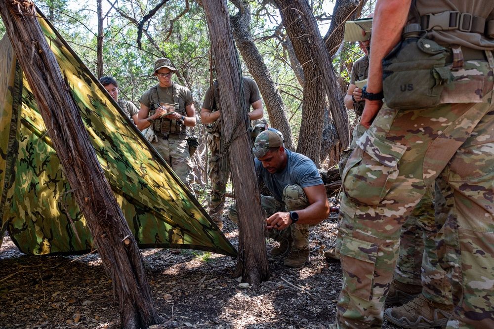 Military personnel conduct field training in a survival exercise