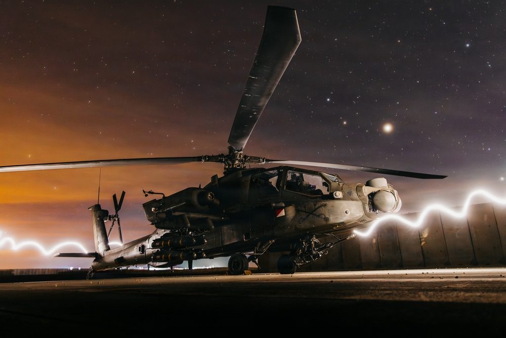 AH-64 Apache attack helicopter armed with Hellfire missiles preparing for a mission