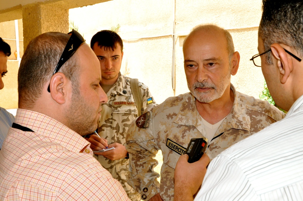 Military officers during planning session reviewing maps and operational documents