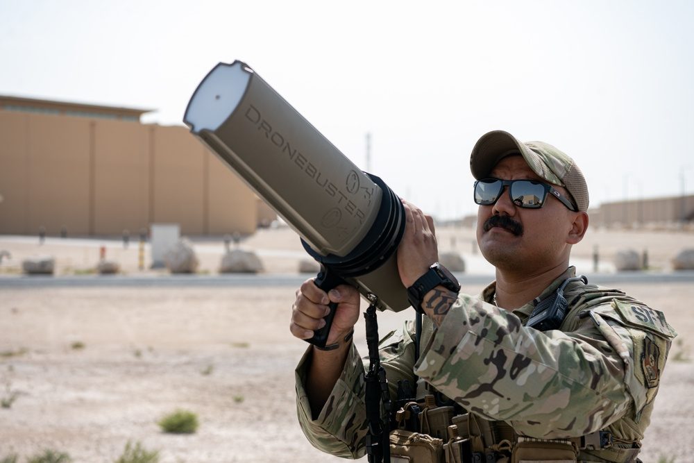 Military security team member using a counter-drone electronic warfare device during training