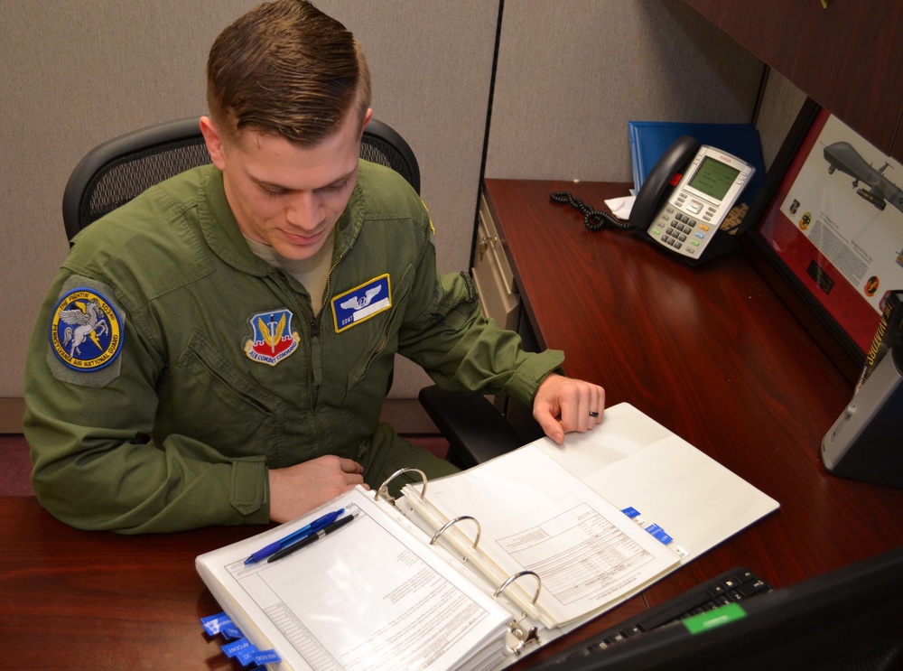 A sensor operator with the 111th Operations Group looks over a manual in the sensor operating section on Horsham Air Guard Station