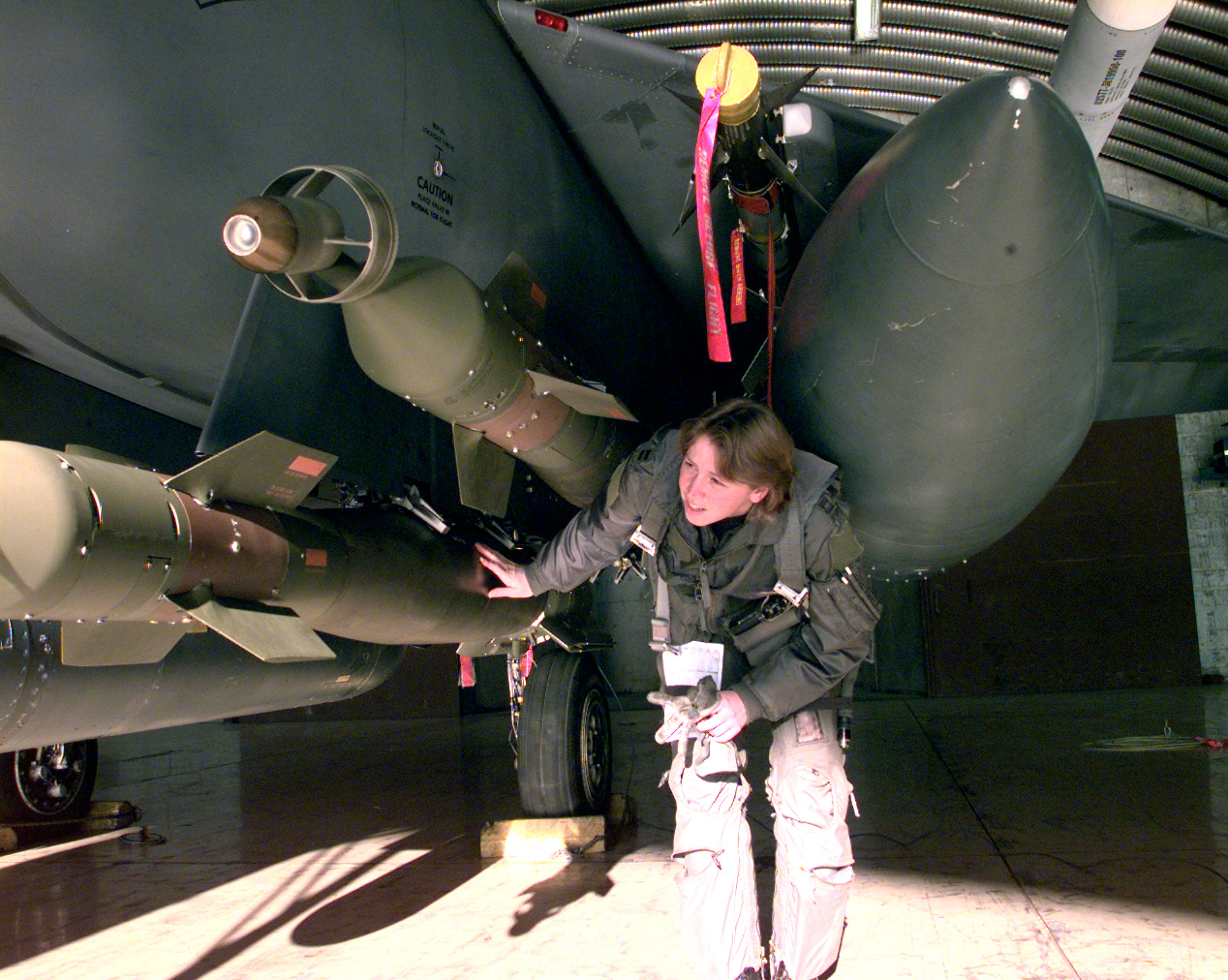 F-15E Strike Eagle loaded with precision-guided munitions on the flight line
