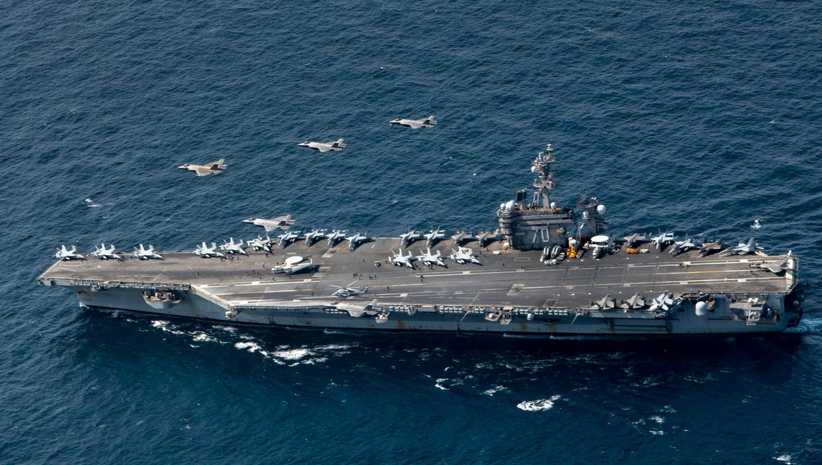 F-35 Lightning II aircraft from the U.S. Air Force, U.S. Navy, and Republic of Korea Air Force flying in formation over the aircraft carrier USS Carl Vinson