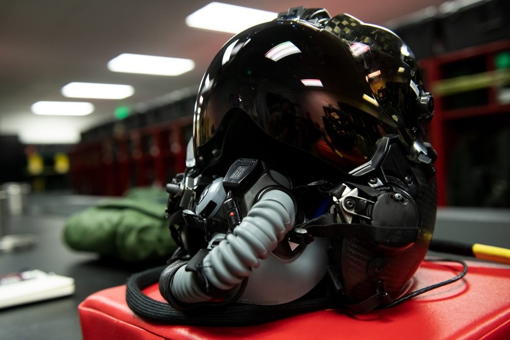 Close-up view of the F-35 Generation III Helmet Mounted Display System resting on a table, showing the visor and sensor components