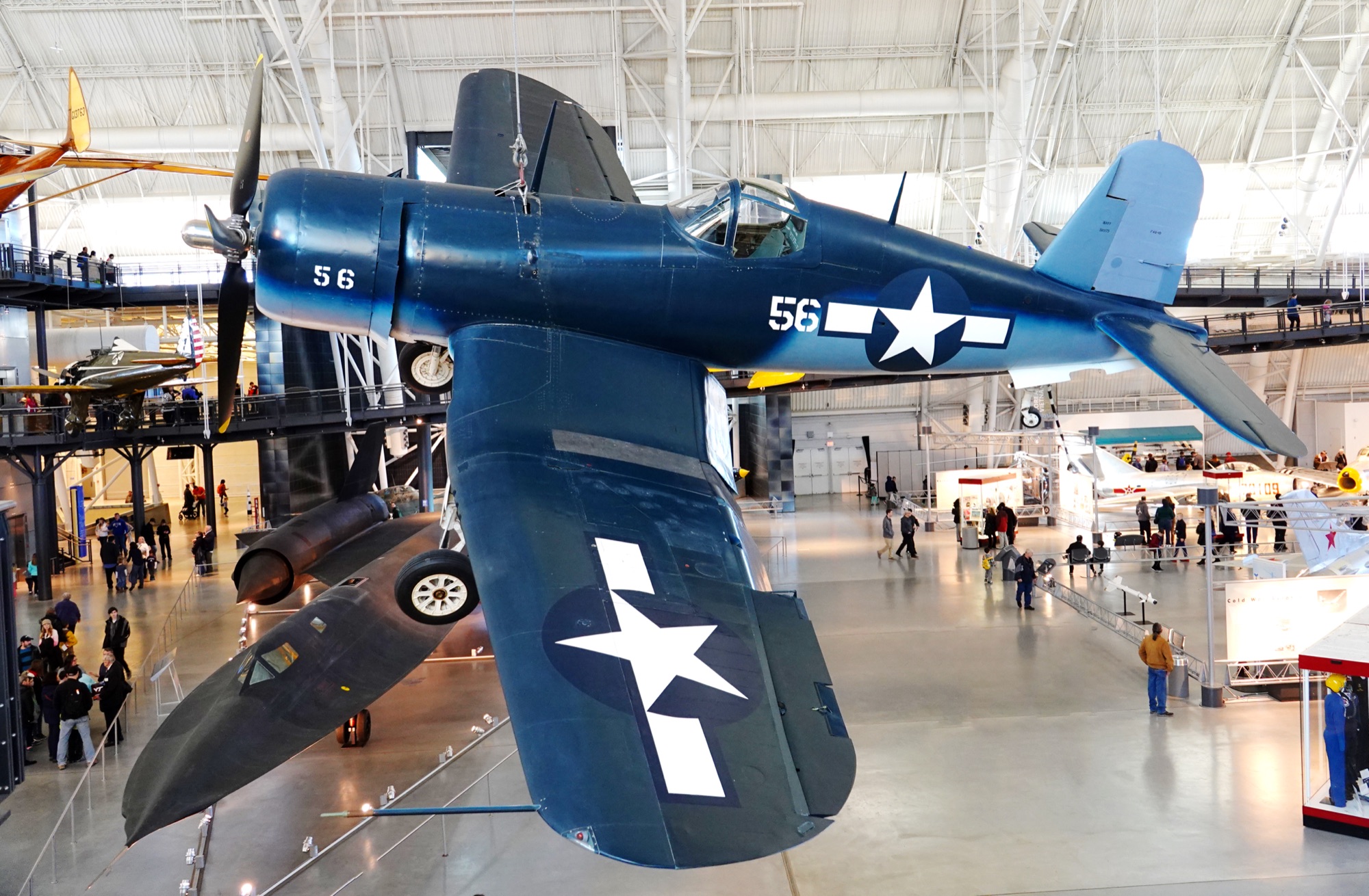 F4U Corsair on an aircraft carrier deck showing the inverted gull wing and large propeller that defined the design