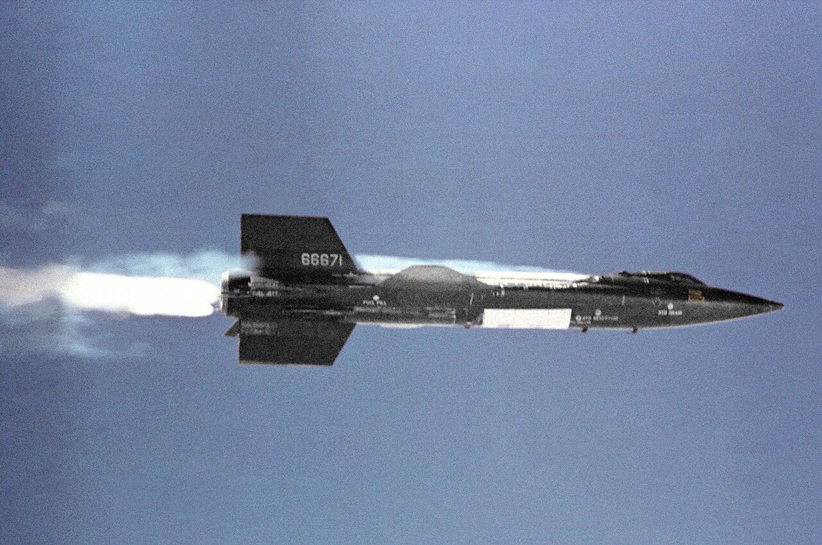 X-15 hypersonic rocket plane in powered flight with exhaust plume