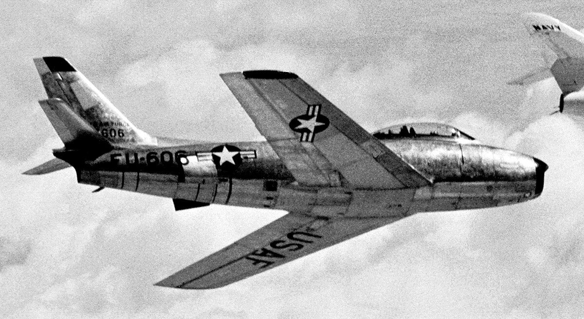 F-86 Sabre in flight above the clouds showing its swept-wing design