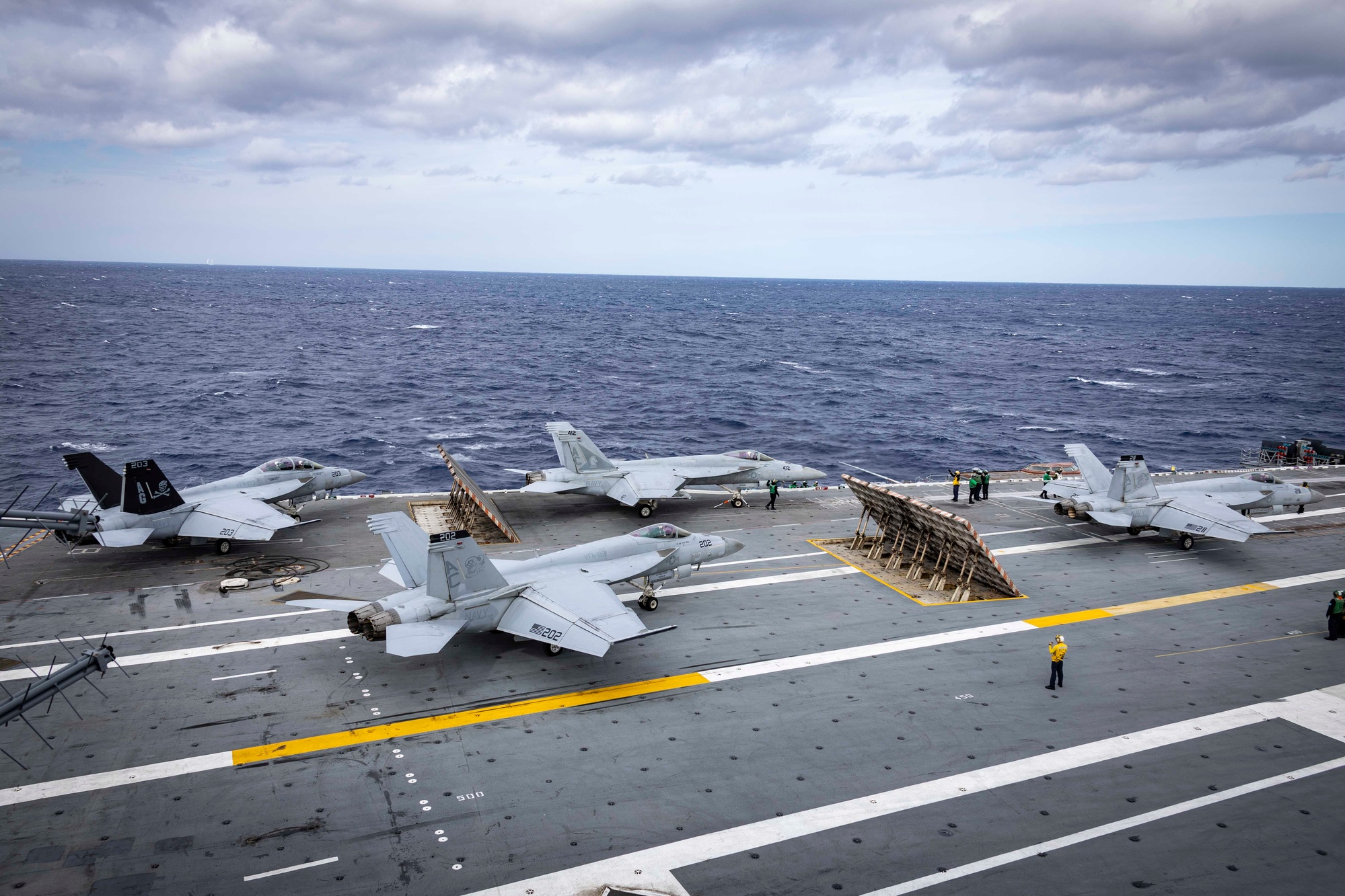 Aerial view of USS Gerald R. Ford flight deck with aircraft operations underway