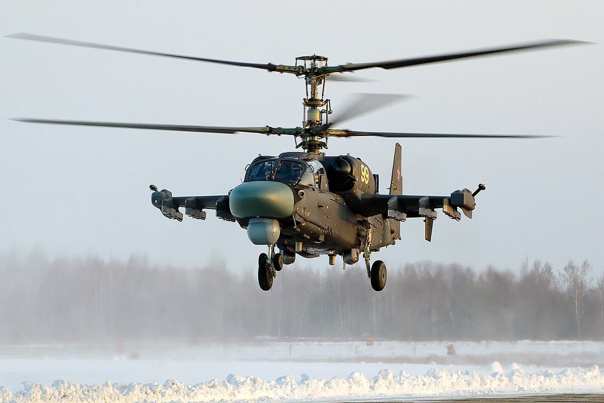Ka-52 Alligator attack helicopter hovering near the ground showing its coaxial contra-rotating rotors