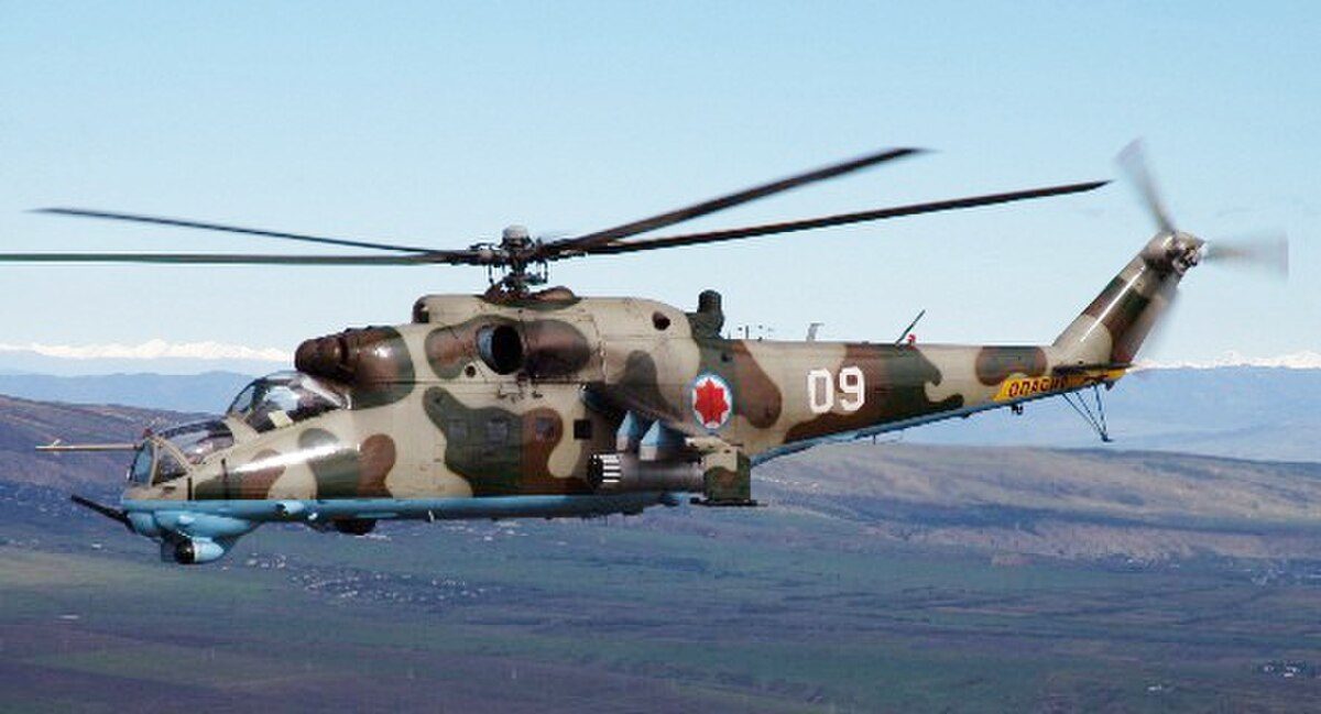 Mi-24 Hind gunship in flight with camouflage paint and stub wings visible