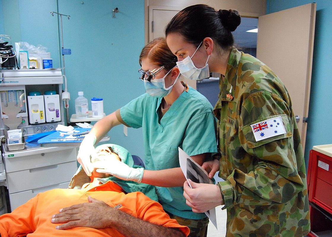 Medical personnel examining a patient aboard USNS Mercy
