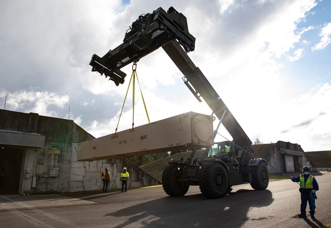 Military vehicles transporting hypersonic missile components on a flatbed trailer