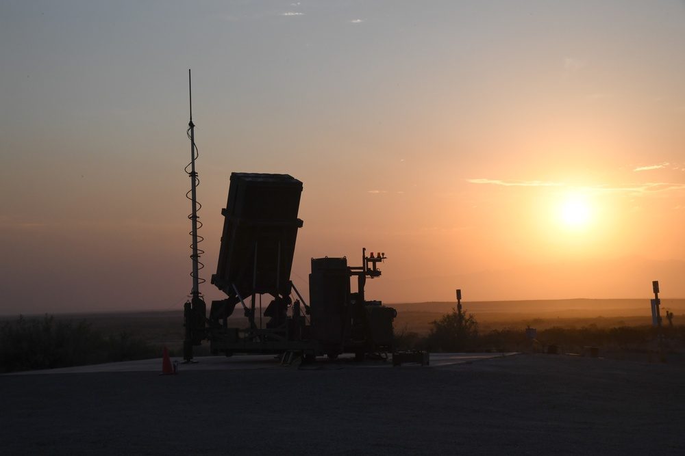 Iron Dome battery silhouetted against sunset ready for intercept operations