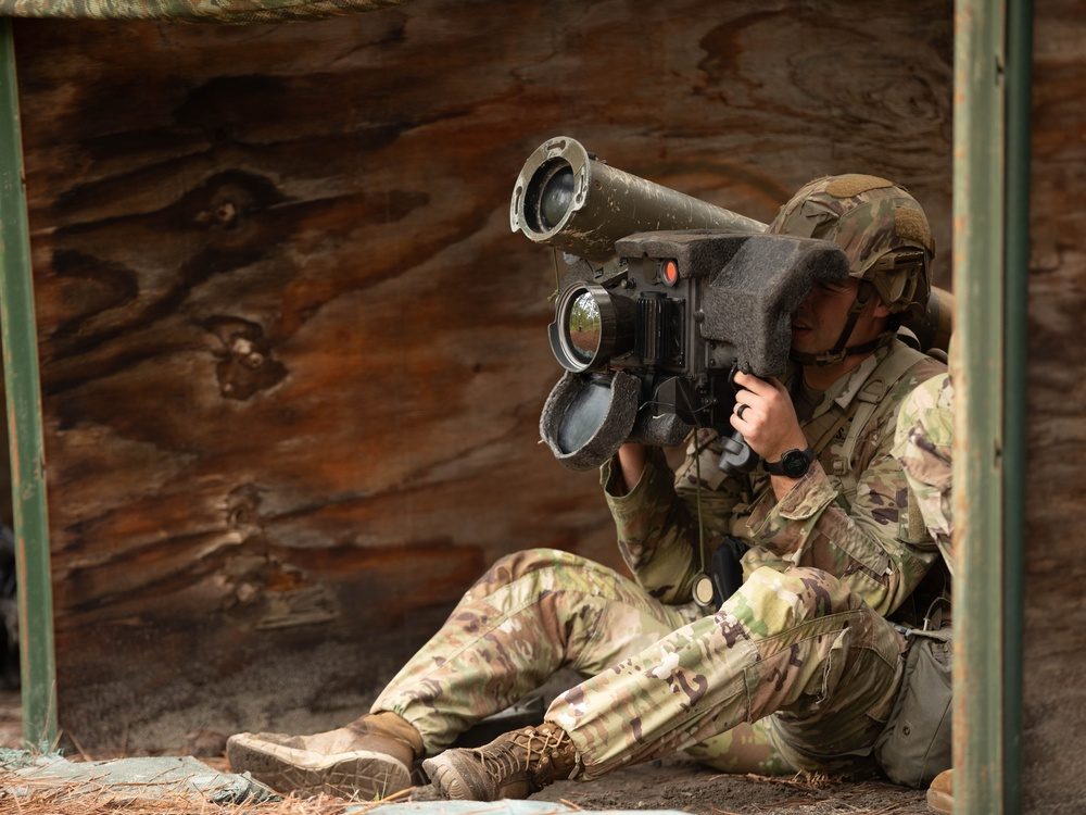 A Paratrooper from the 82nd Airborne Division aiming an FGM-148 Javelin anti-tank weapon system during Expert Soldier Badge qualification at Fort Liberty