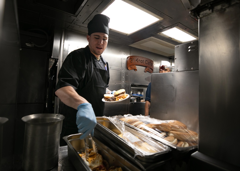 A Navy culinary specialist preparing food in a ship's galley