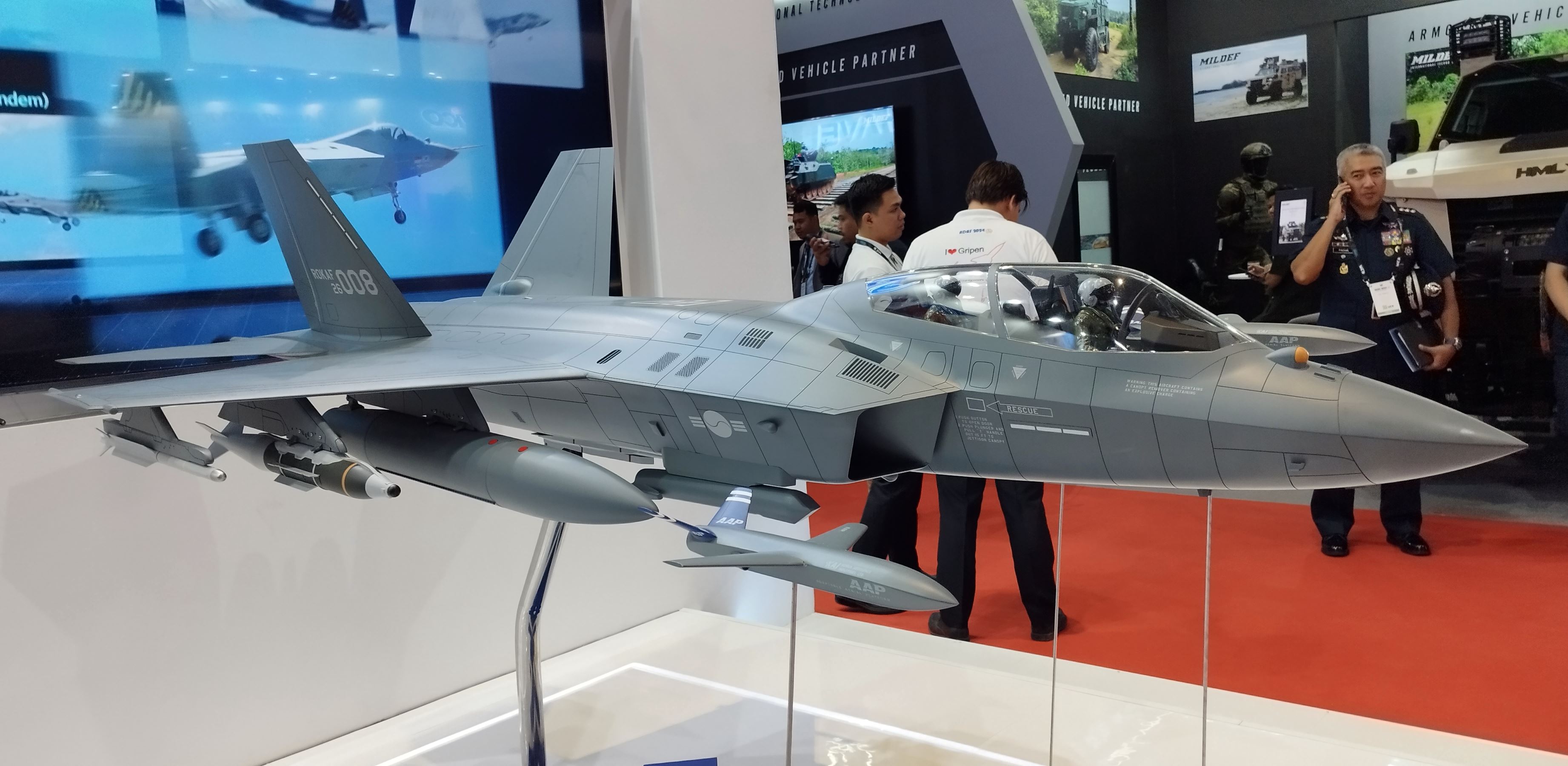 Two KF-21 Boramae prototypes flying in formation over South Korean countryside