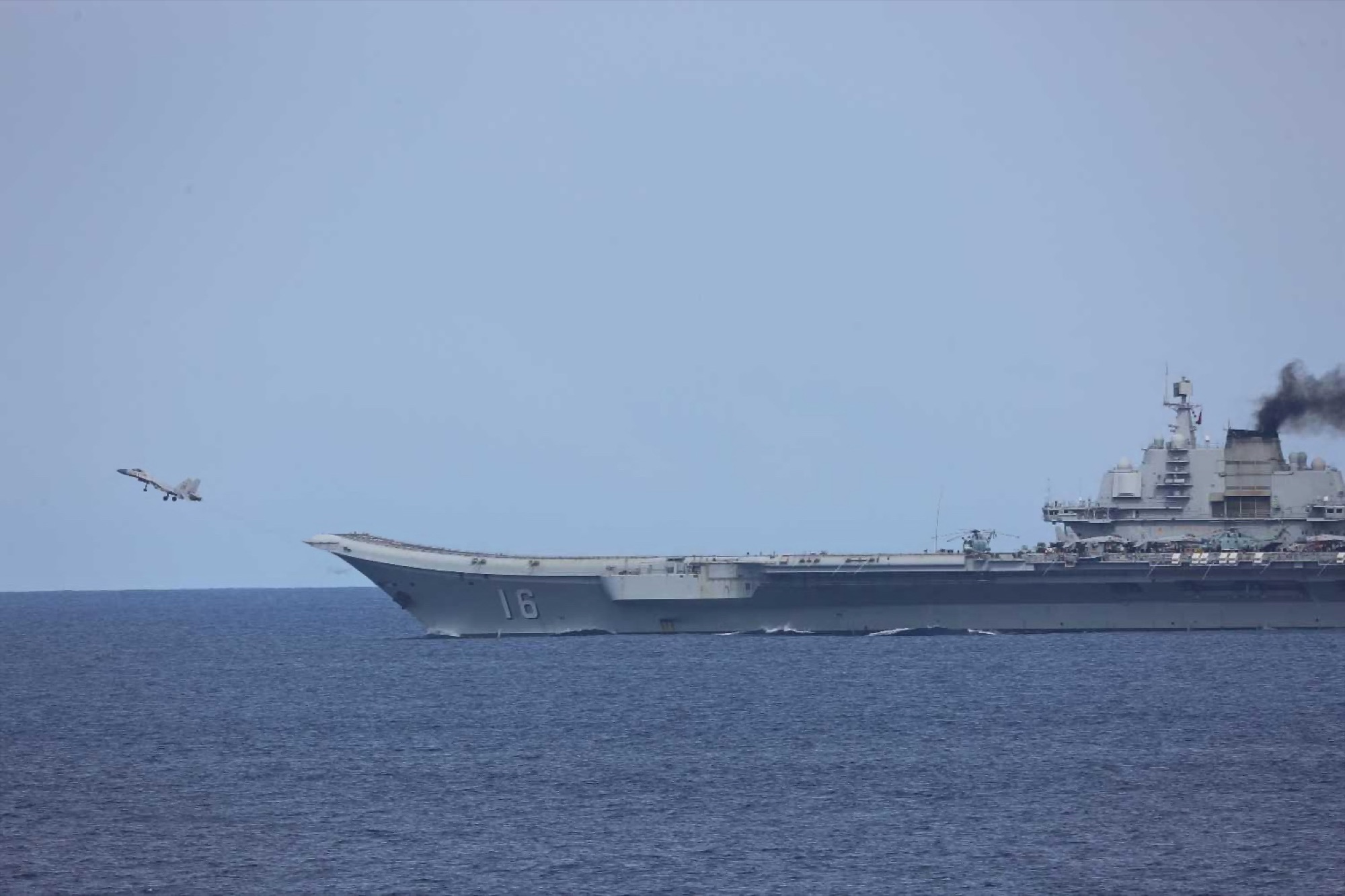 Chinese aircraft carrier Liaoning conducting flight operations with J-15 fighters on the flight deck