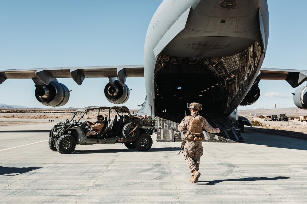 Marines load tactical vehicles onto a C-17 Globemaster III cargo aircraft