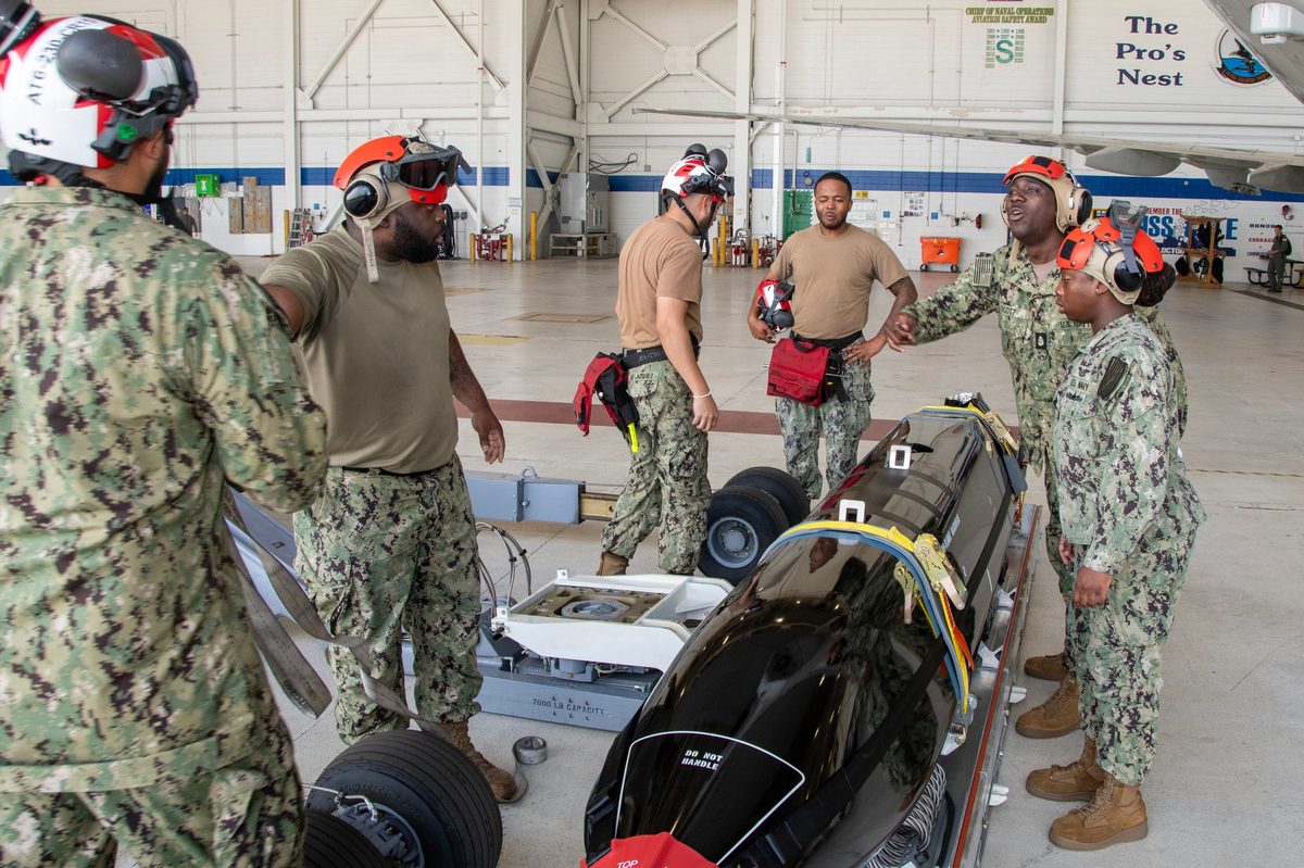 Sailors from Patrol Squadron 30 conducting a pre-installation inspection of an AGM-158C LRASM missile at Naval Air Station Jacksonville