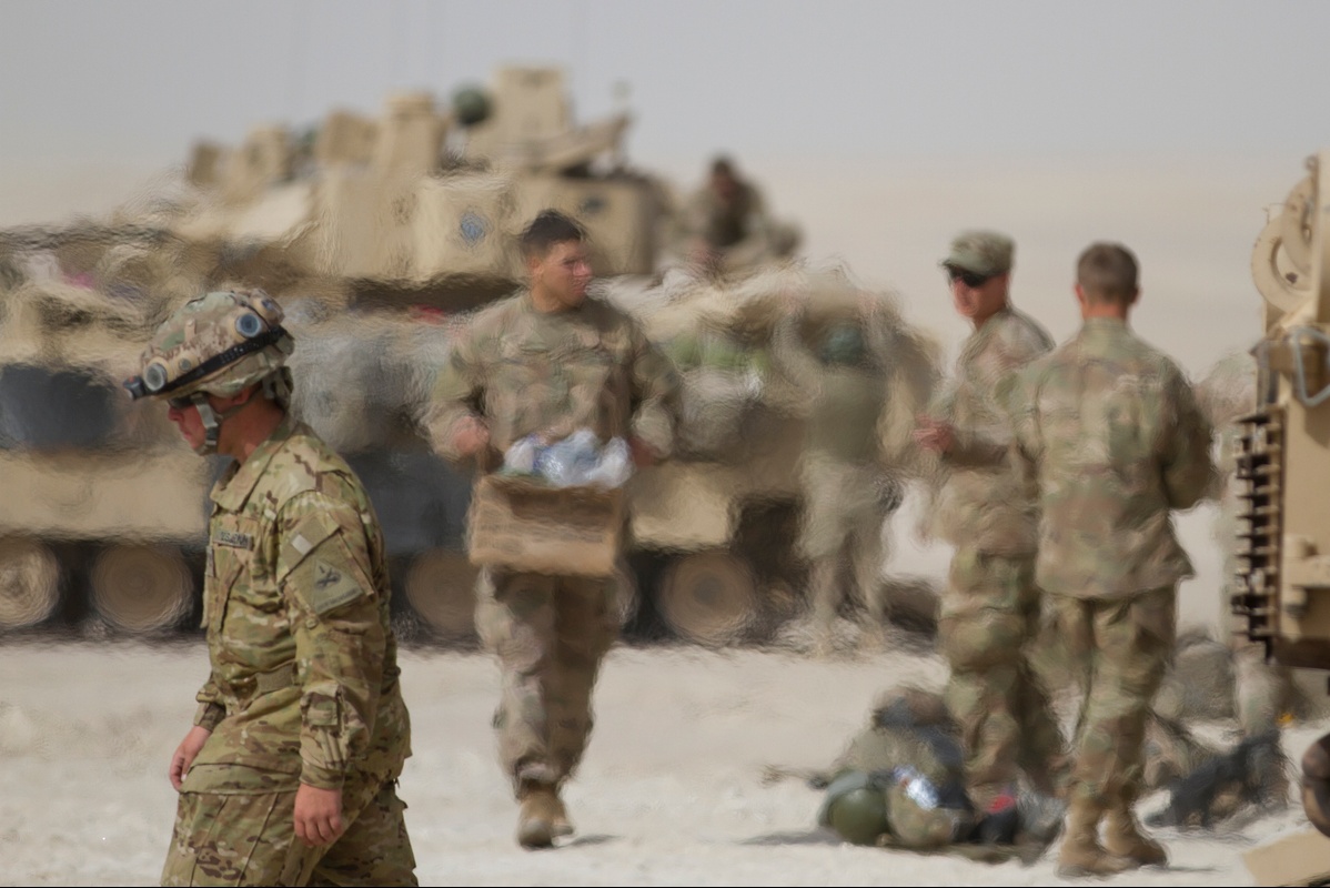 M1 Abrams tank operating in desert conditions with heat waves visible