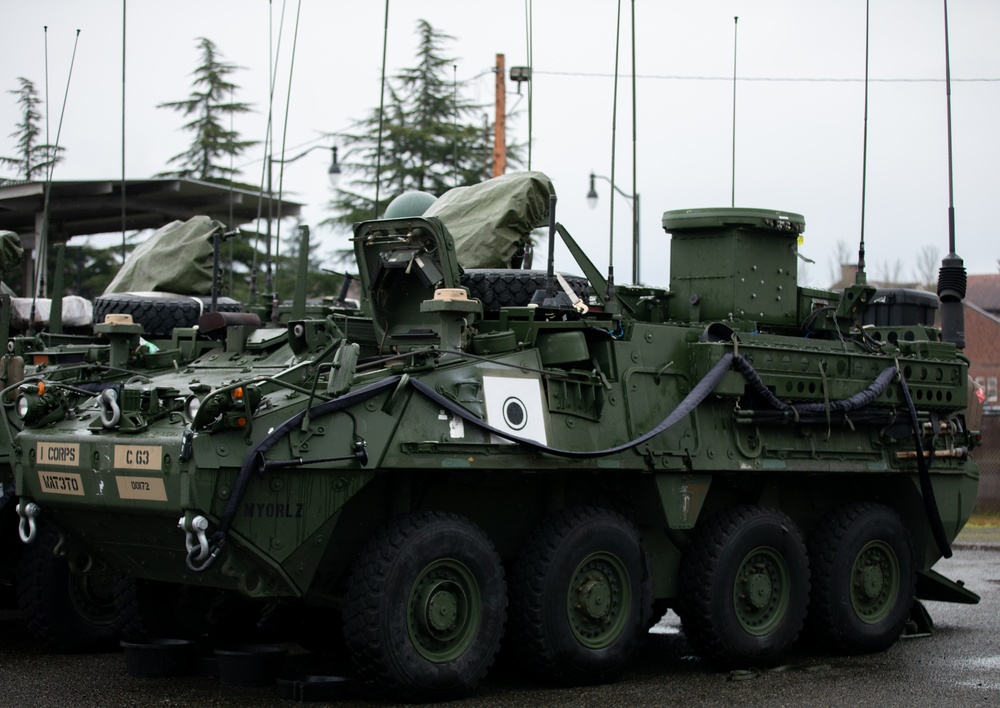 Military mechanic performing maintenance on armored vehicle