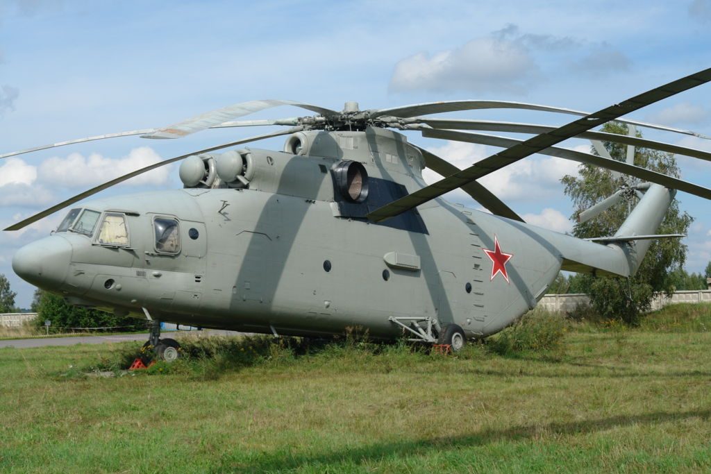 Mi-26 Halo helicopter on the ground in military green paint with red star and eight-blade rotor visible