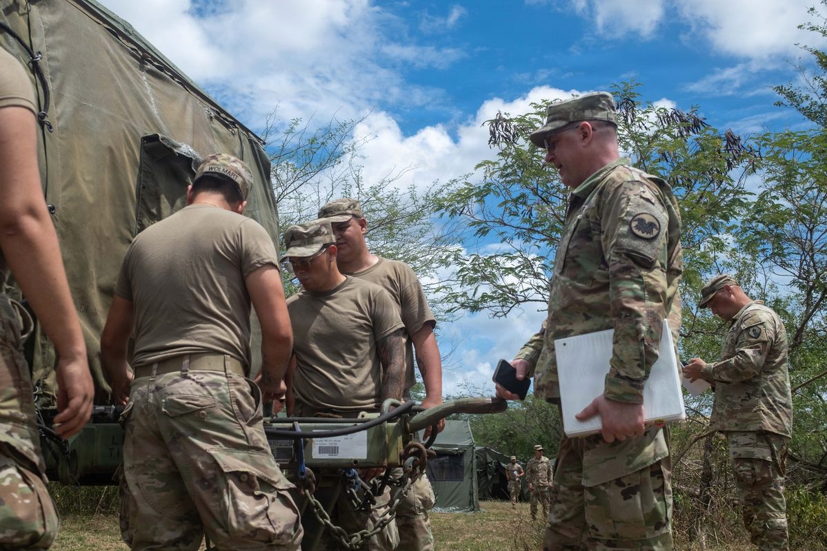 Soldiers being served a meal at a military dining facility during a field training exercise