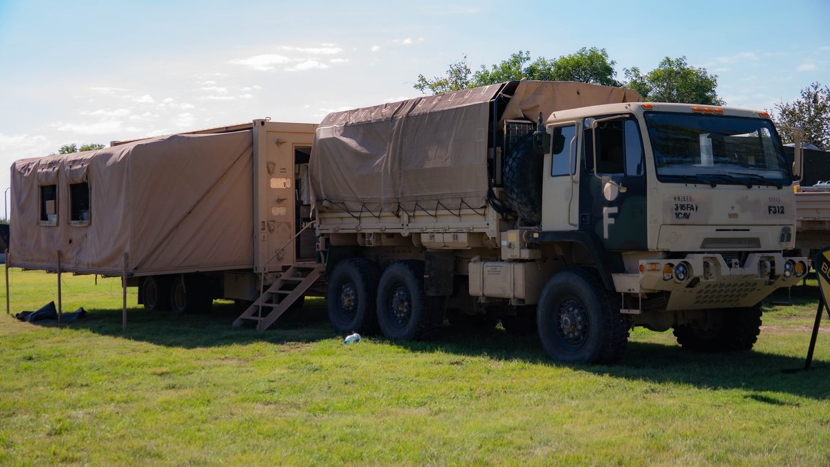 Contents of a military MRE (Meal Ready to Eat) spread out showing all components including entree, sides, and accessories