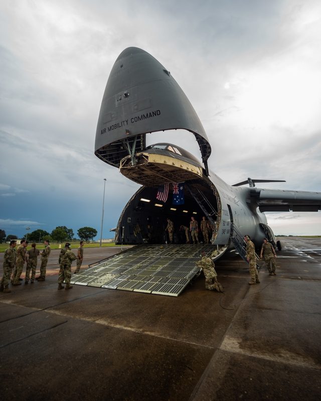 U.S. Marines observing the loading of a Medium Tactical Vehicle Replacement into a C-5M Super Galaxy at RAAF Base Darwin, Australia