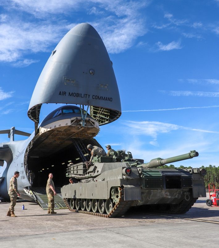 Soldiers and Airmen loading a Bradley Fighting Vehicle into a C-5 Galaxy cargo aircraft at Hunter Army Airfield, Georgia
