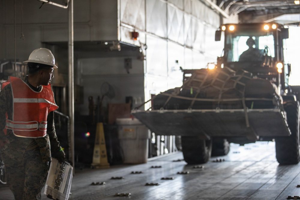 Marines loading military equipment onto the USNS Guam at Marine Corps Air Station Iwakuni, Japan