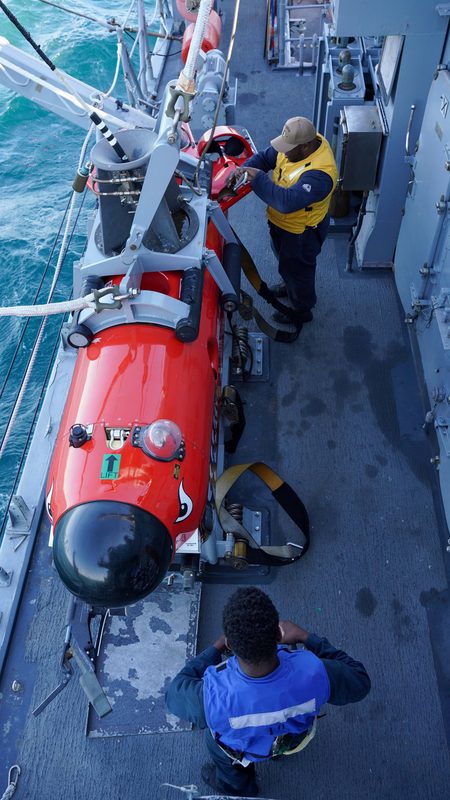 Sailors aboard USS Warrior mine countermeasures ship operating mine neutralization equipment during exercises