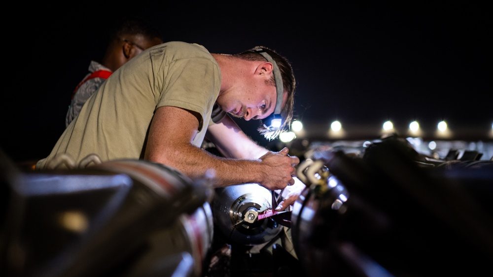 Airman loading a Mk 62 Quickstrike mine onto a bomber aircraft during a training exercise at Barksdale Air Force Base