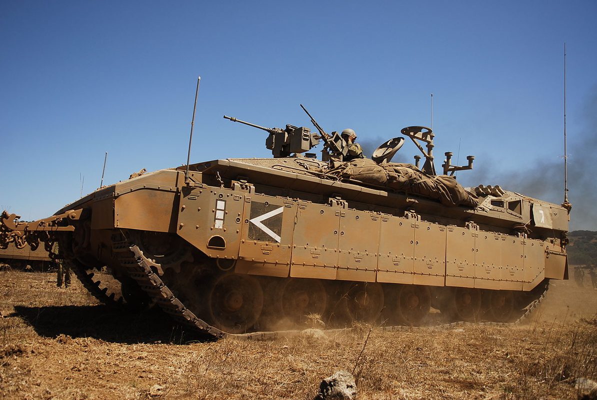 Namer APC with rear door open showing the troop compartment and infantry dismounting during an exercise