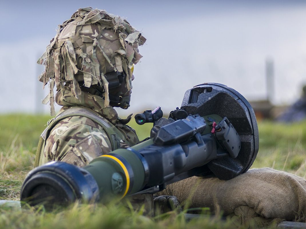 Soldier carrying an NLAW anti-tank missile system on his shoulder