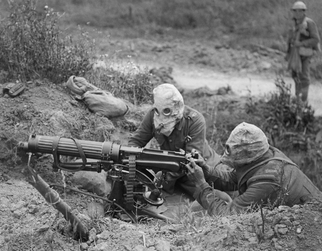 British Vickers machine gun crew wearing gas masks while operating their weapon, Western Front, World War I