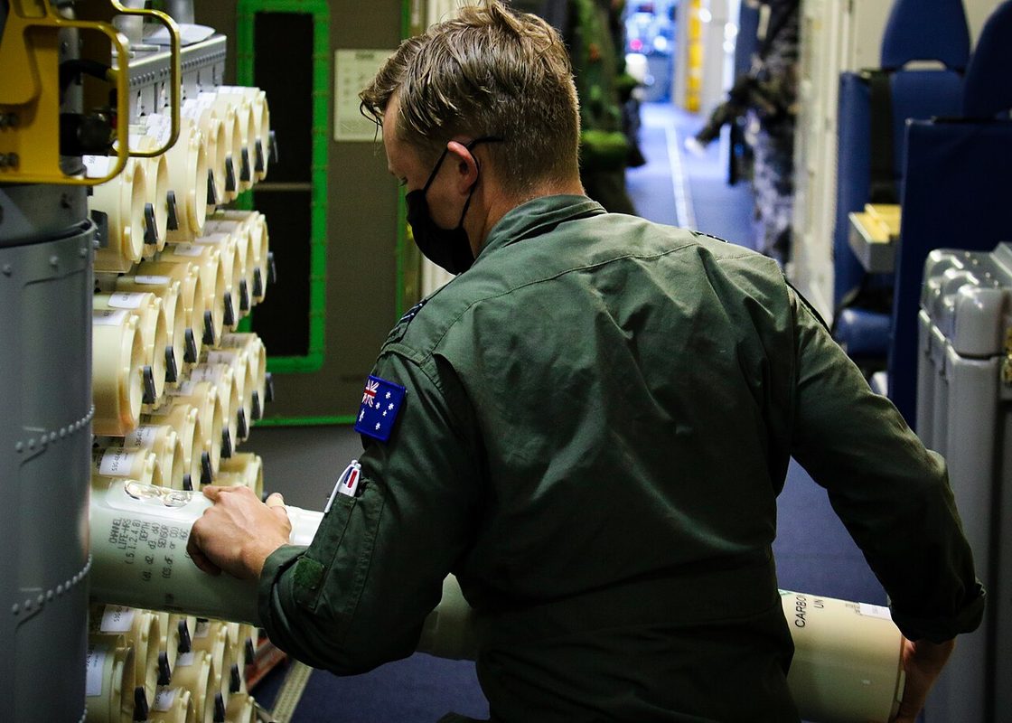 Aircrew loading sonobuoys aboard a P-8A Poseidon during RIMPAC 2022