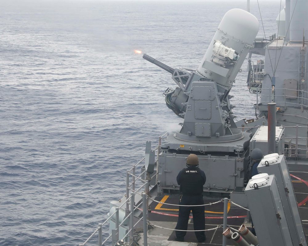 Close-up view of a Phalanx CIWS system showing the white radome and six-barrel Gatling gun