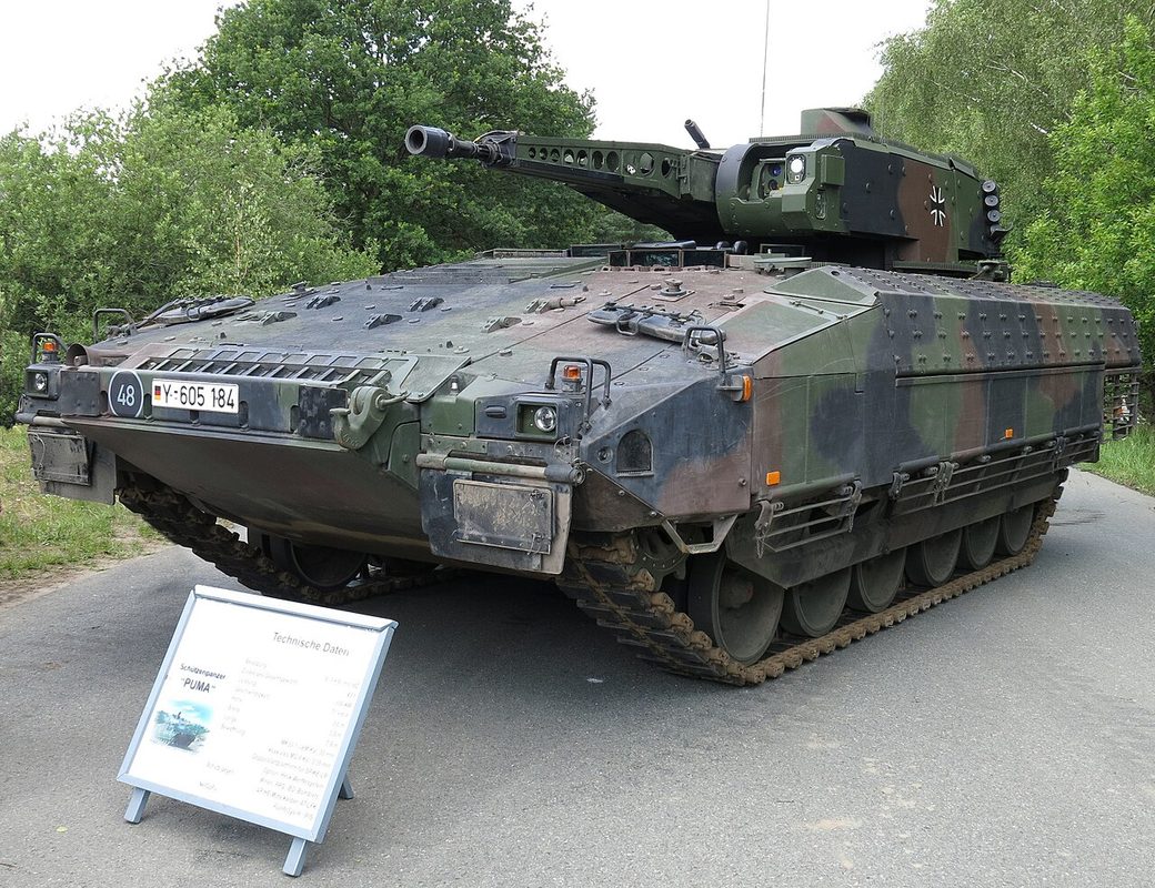 Puma infantry fighting vehicle advancing on a road with Bundeswehr iron cross marking