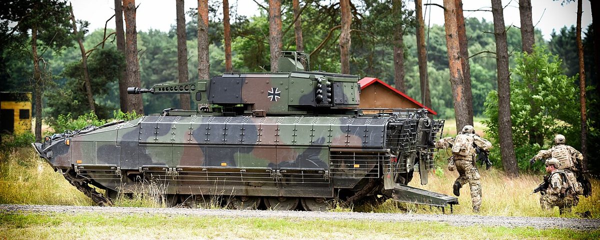 Puma IFV parked in a field with dismounted troops alongside during an exercise