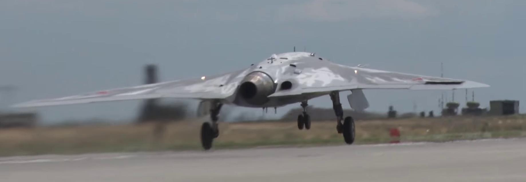 S-70 Okhotnik drone showing its flying wing planform from above during a test flight