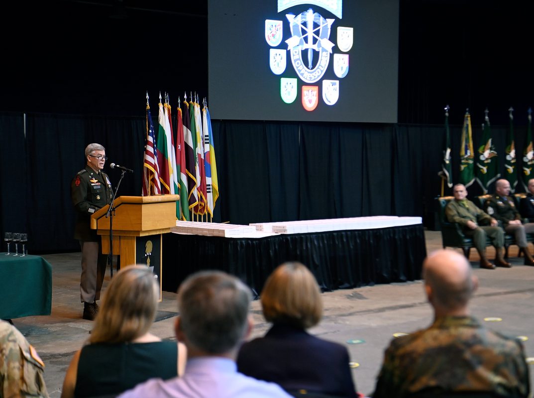 Soldiers assigned to the John F. Kennedy Special Warfare Center and School don their green berets for the first time during a Regimental First Formation at Fort Bragg, North Carolina, February 2022. U.S. Army photo by K. Kassens.