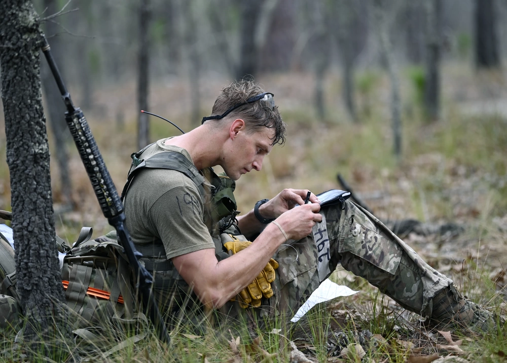 Special Forces candidate plots his next movement during land navigation training at Camp Mackall, North Carolina, April 2021. U.S. Army photo by K. Kassens.